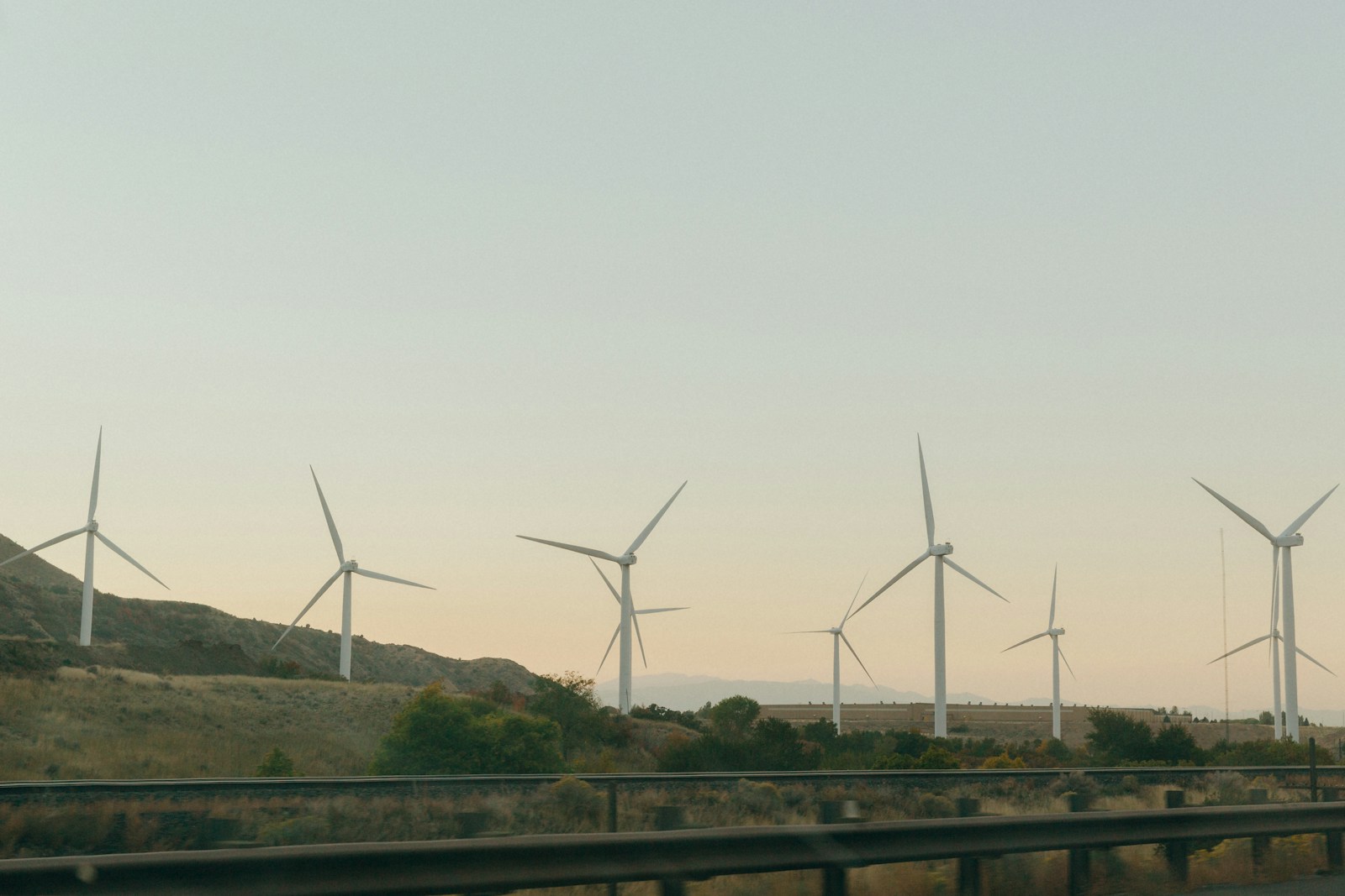 a highway with a bunch of windmills in the distance